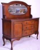 An Edwardian mahogany mirror back sideboard raised on shaped legs with a wide base with short
