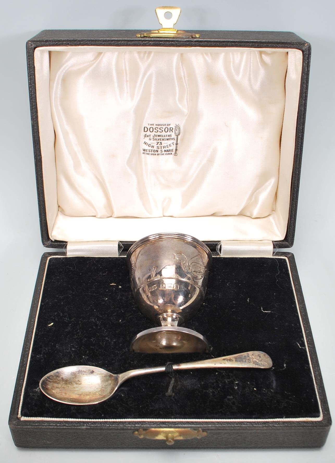 A silver hallmarked engraved child's egg cup and spoon christening set, the spoon and cup each chase