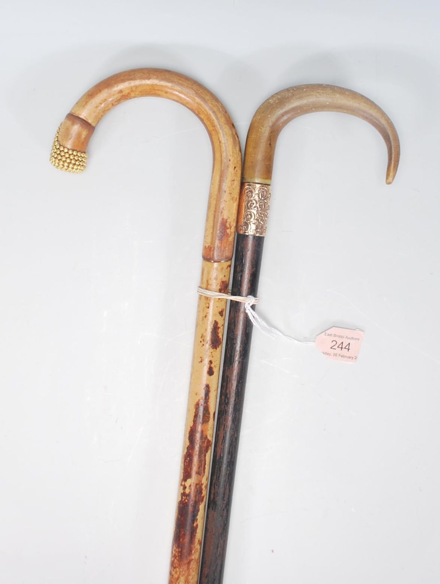 A pair of 20th century wooden walking sticks havin