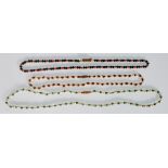 A group of three vintage ladies beaded necklaces to include a pearl and red stone necklace, a