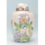 A 20th century Chinese ginger jar decorated in an Art Deco taste with kingfisher, butterfly and