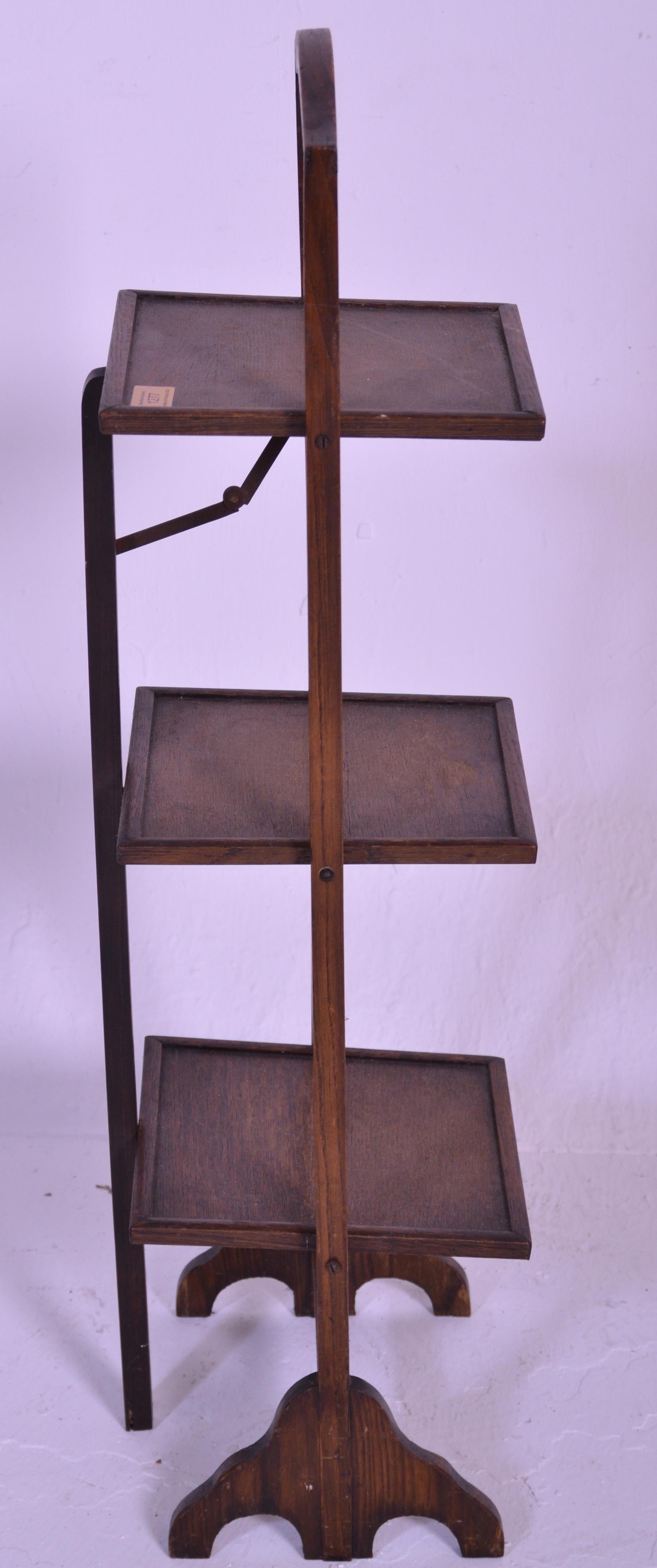 A vintage early 20th Century 1930's oak three tier folding cake stand of square form raised on - Image 3 of 4