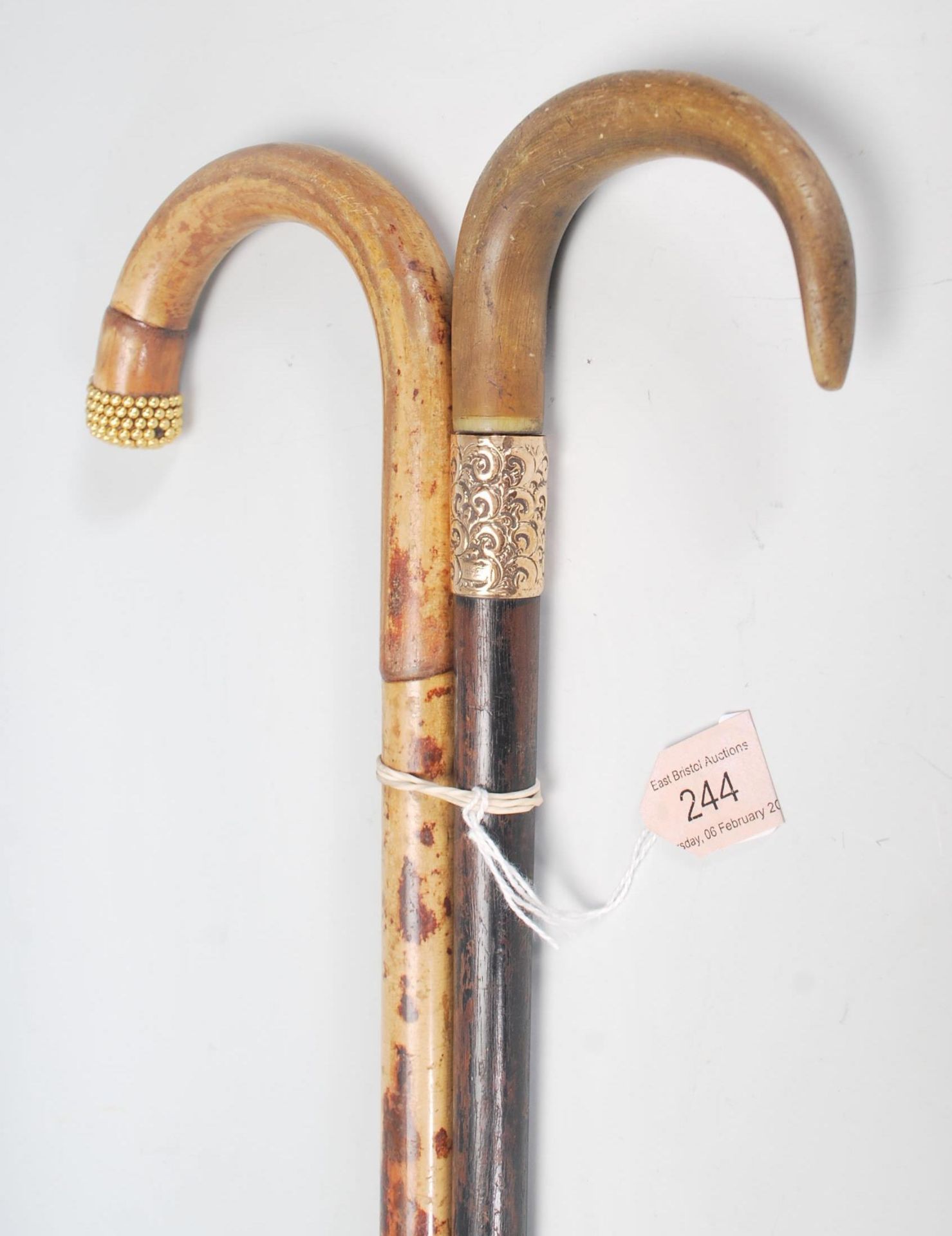A pair of 20th century wooden walking sticks havin - Image 3 of 9