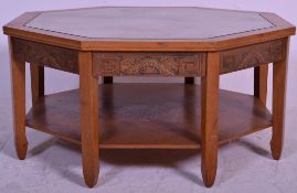 A mid century Chinese hardwood octagonal coffee table having glass top covering carved Chinese