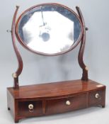 A 19th Century Georgian mahogany bow fronted toilet swing mirror, the oval glass mirror and shaped