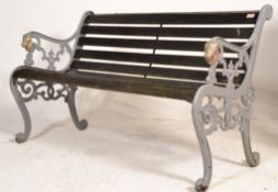 A 19th Century Victorian garden bench having cast iron sides with scrolled decoration and lions