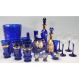 A good collection of 20th Century blue glassware to include a large blue glass vase, decanters,