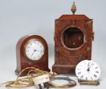 A pair of 20th century mantel clock having white enamel face. The small dome top clock has wind up