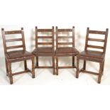 A set of 4 early 20th century carved oak Jacobean revival dining chairs. Raised on block and
