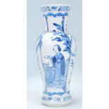 A 19th Century Chinese vase of baluster form having a waisted body hand painted in blue and white
