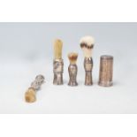 A good group of four vintage 20th Century silver handled shaving brushes of varying sizes and shapes
