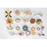 A collection of 20 vintage mid 20th Century fashion brooches to include a selection of designs