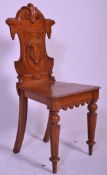 A Victorian carved oak 19th century armorial hall chair. Raised on ring turned legs with panel