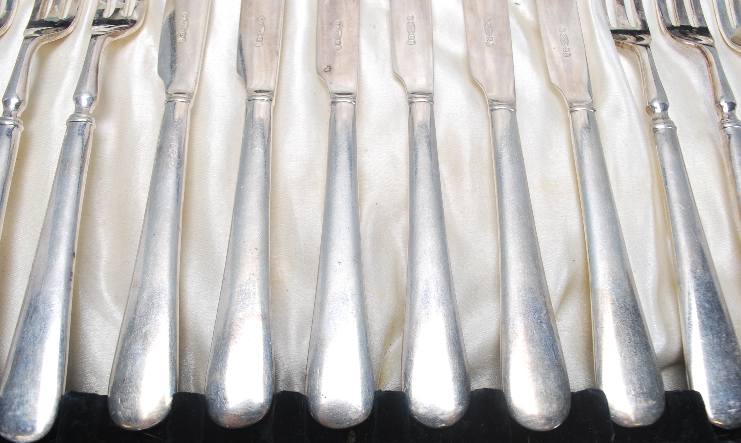 A vintage silver plated cake knife and fork set consisting of six knives and forks set within its - Image 5 of 9