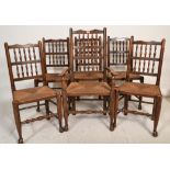 A set of six 20th Century oak Lancashire style spindle back dining chairs with rush seats and simple