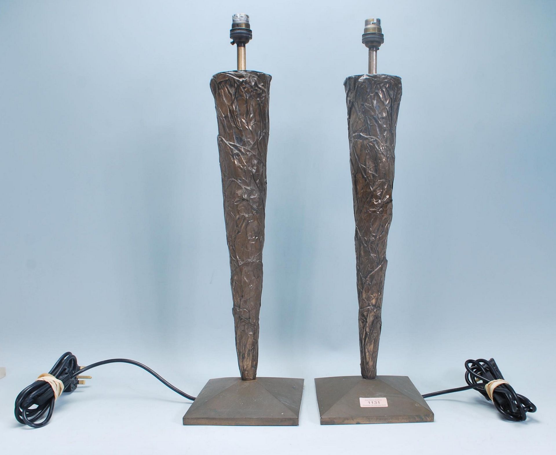 A good pair of Art Deco style tall bronze effect table lamps. Each of tapering form being raised