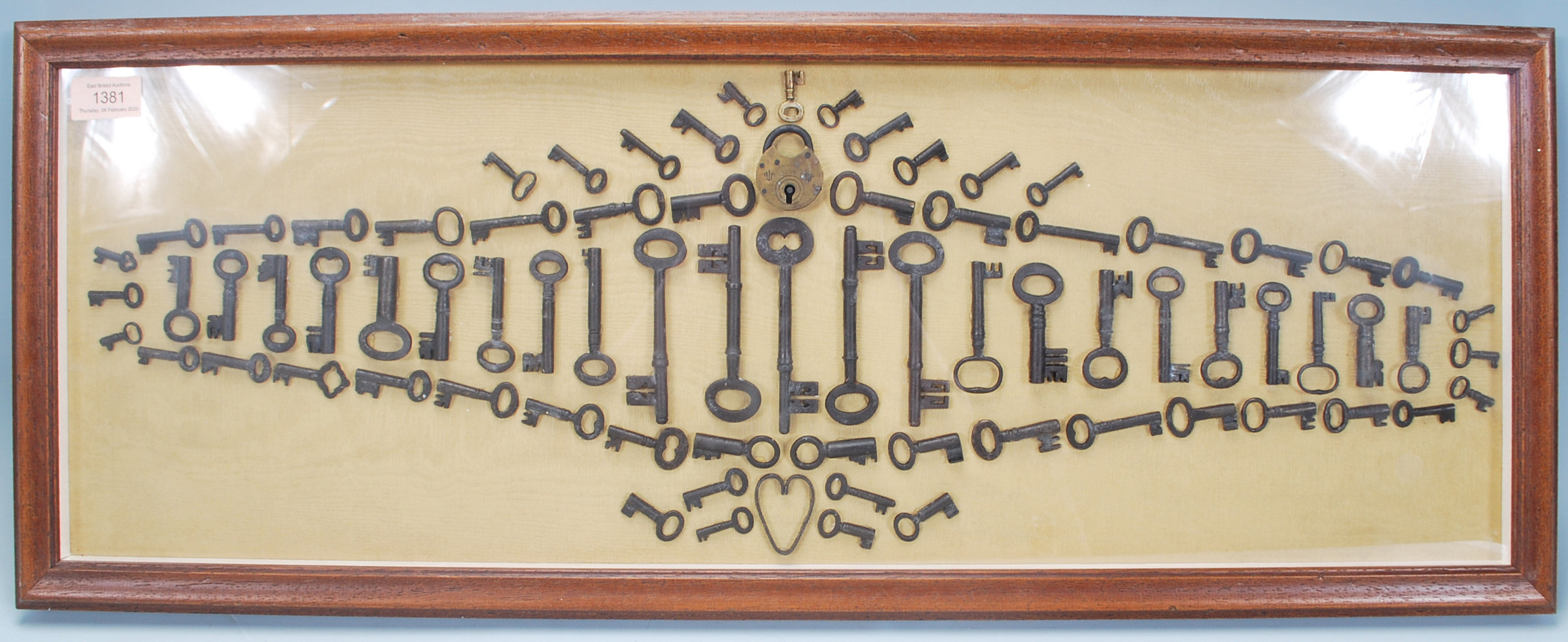 A selection of 19th Century antique keys and locks arranged into a geometric pattern and framed, set