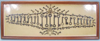 A selection of 19th Century antique keys and locks arranged into a geometric pattern and framed, set