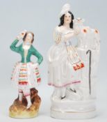 Two 19th Century Victorian Staffordshire figurines to include a figure of a lady with a sheep and