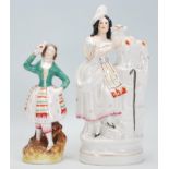 Two 19th Century Victorian Staffordshire figurines to include a figure of a lady with a sheep and