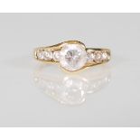 An English hallmarked 9ct yellow gold ladies ring set a central round faceted cut CZ flanked by