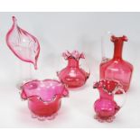 A small group of vintage 20th Century cranberry glassware to include a leaf vase, large and small