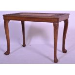 A 20th Century carved wood low occasional table having an intricately carved table top, decorated