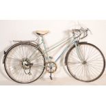 A vintage retro 20th Century racing / road bike / bicycle by Peugeot having original fittings and