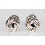 A pair of sterling silver mens cufflinks. The cufflinks take the form of a simple circular knot