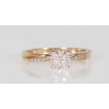 A 9ct yellow gold ladies evening cluster ring set with a central cluster of diamonds with diamond