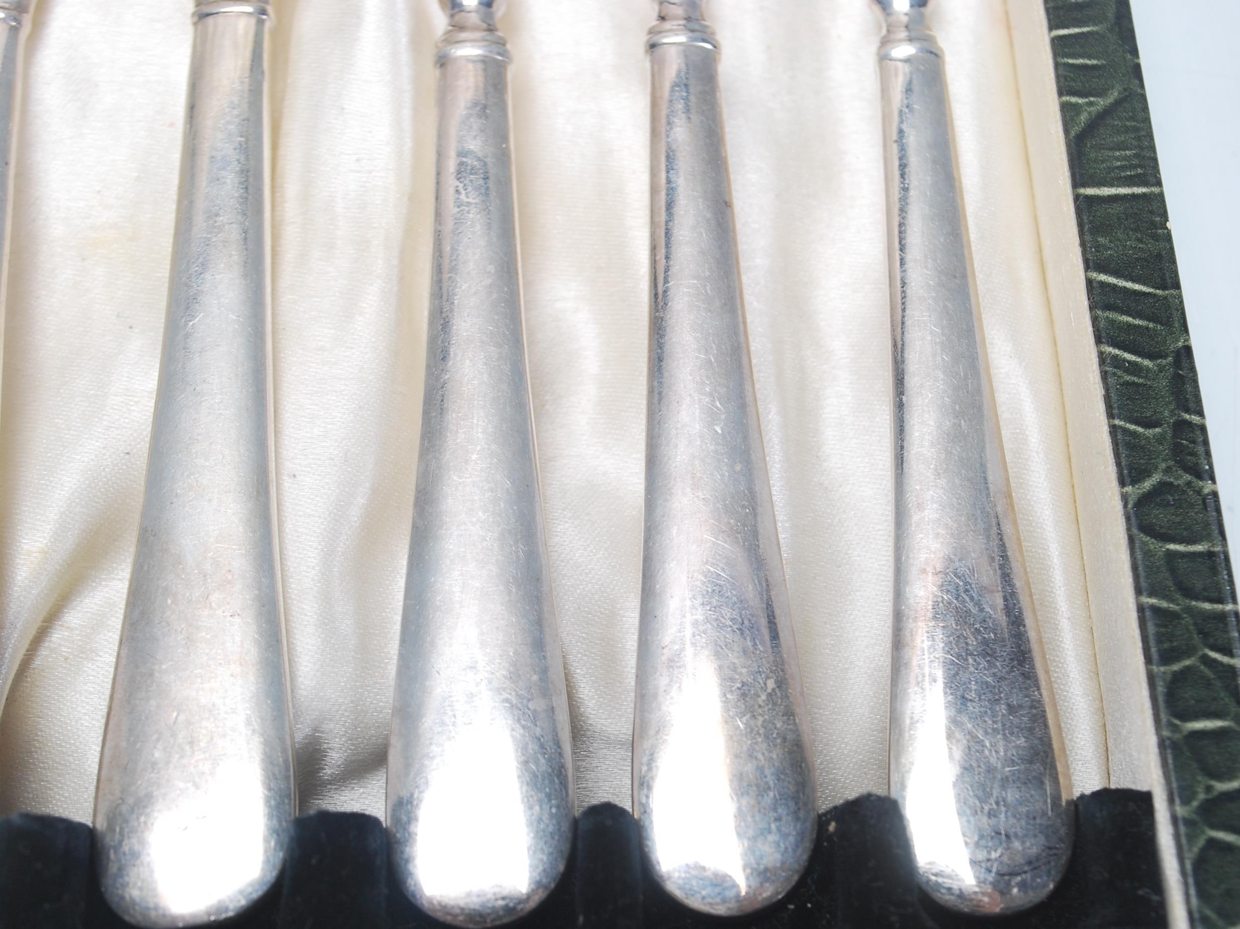 A vintage silver plated cake knife and fork set consisting of six knives and forks set within its - Image 7 of 9