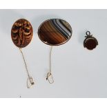 A group of 19th Century Victorian brooches to include a banded agate brooch of oval form, a carved