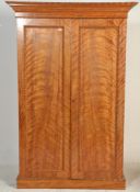 A Victorian 19th century satin birch wood linen press. Raised on a plinth base with short and deep