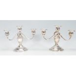 A pair of 20th century sterling silver three sconce candelabra. Marked to the base for Revere