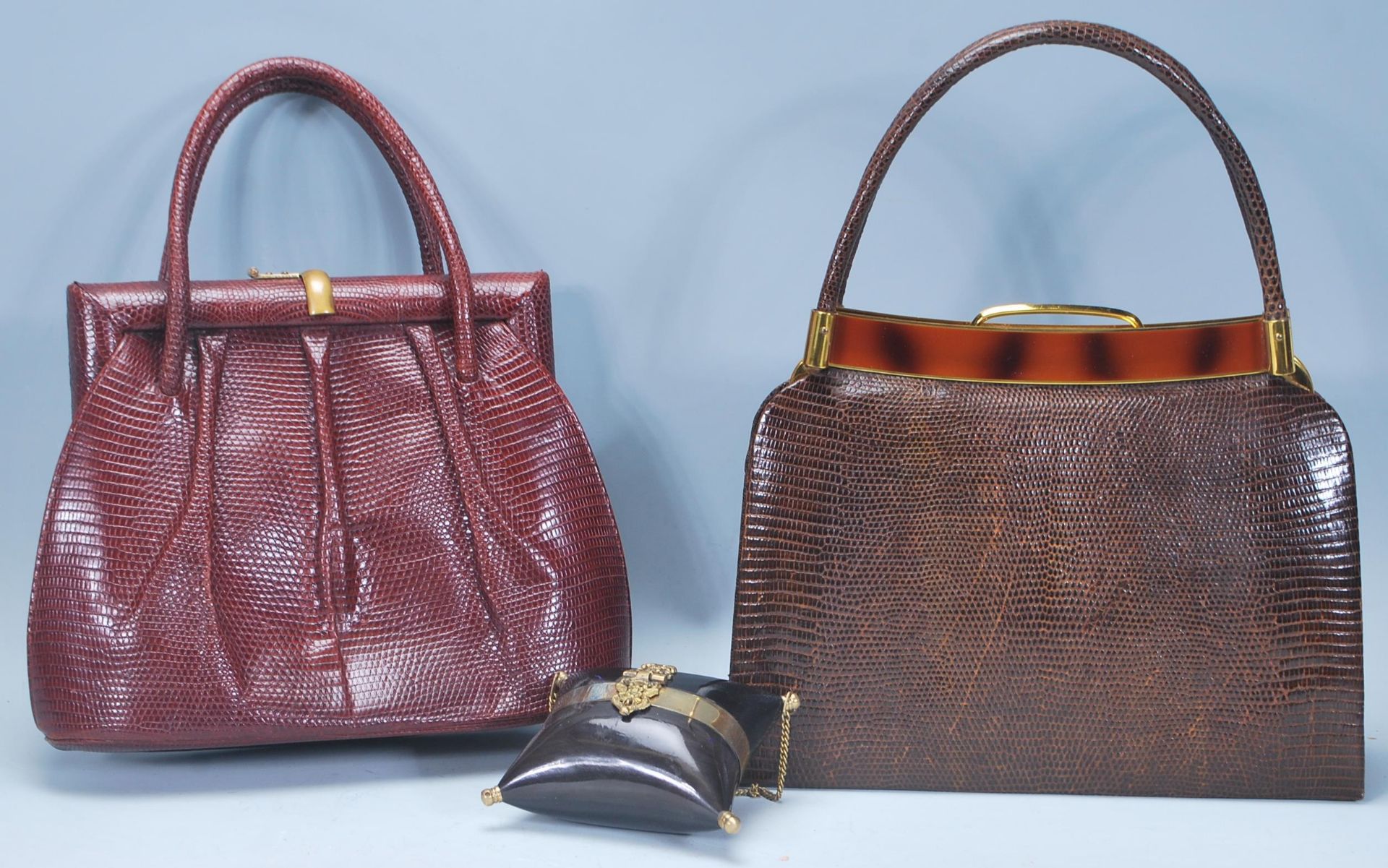 A group of three vintage handbags to include a red leather crocodile handbag, a brown crocodile skin