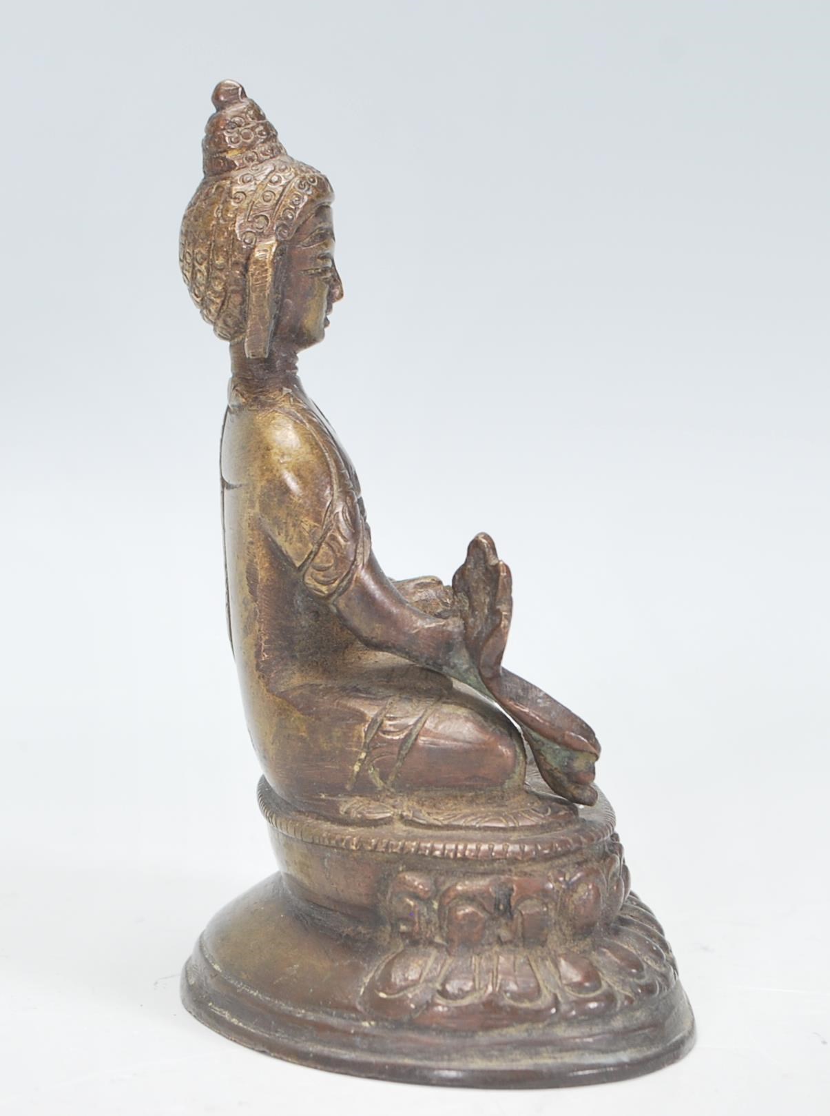 An Indian bronze figurine / ornament in the form of Buddha, modelled in a seated position raised - Image 2 of 6