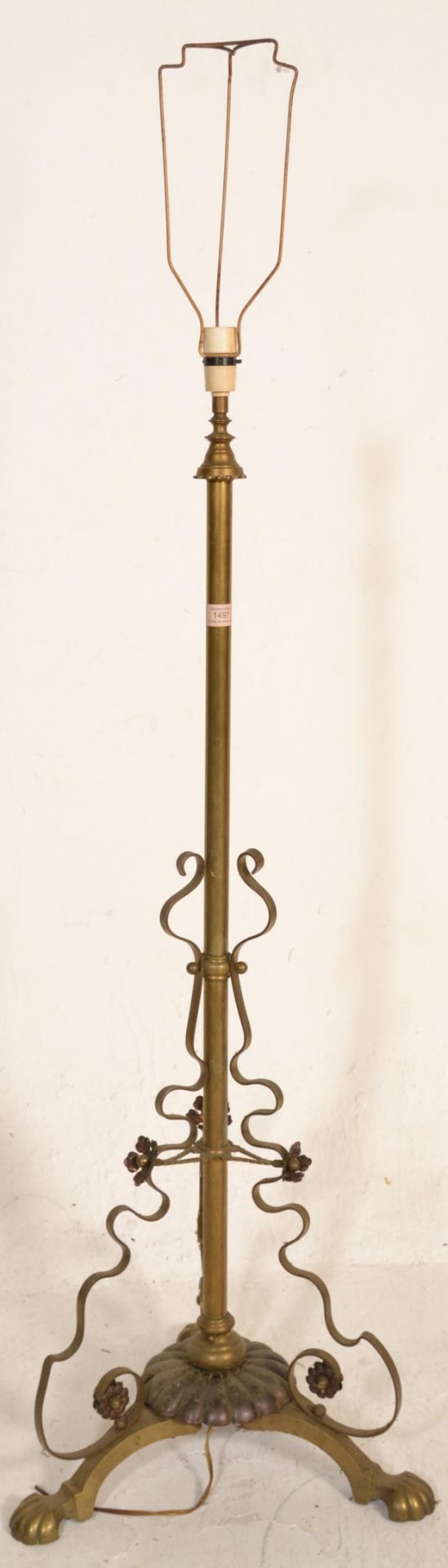 A vintage early 20th Century converted to electric brass floor standing lamp having a decorative