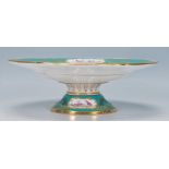 A 19th Century French style centrepiece tazza having a green ground with panels of hand painted