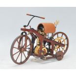 A Franklin Mint precision model of an 1885 Daimler single track motorcycle bike complete with
