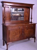 An Edwardian mahogany mirror back sideboard raised on shaped legs with a wide base with short