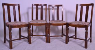 A set of 4 1940's oak dining chairs of utility form. Raised on squared legs united by stretchers