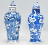 Two Chinese vases of baluster form each hand painted in the prunus pattern, both having flared rim