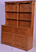 A good quality early 20th century country pine Welsh dresser. The base with 2 cupboard doors under