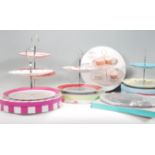 A group of six contemporary china cake stands to include a Rosies Pantry two tier cake stand, two