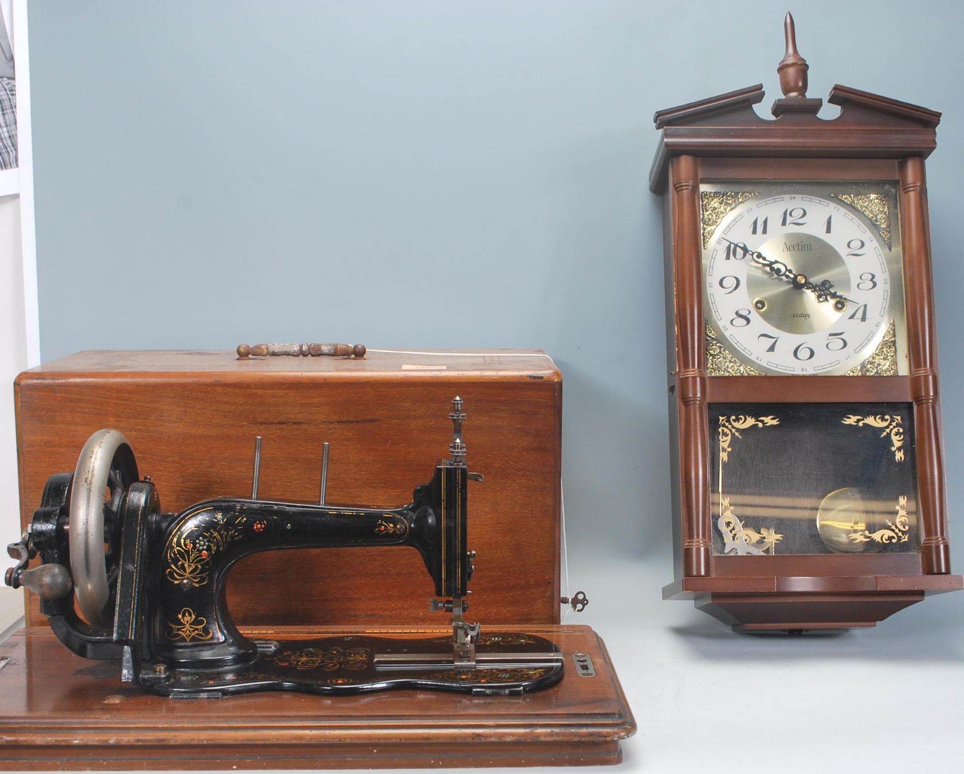 An Edwardian mahogany inlaid cased Singer sewing machine, the case complete with the key housing