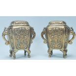 A pair of 20th Century Chinese bronze incense burners of rectangular form having chamfered edges,