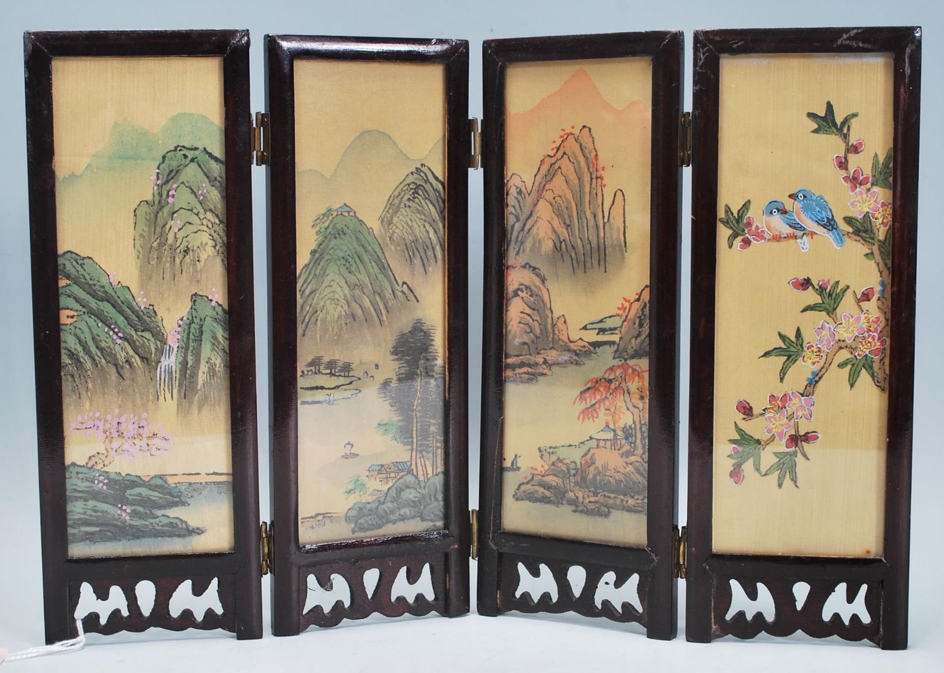 A 20th Century Chinese wooden table screen of small proportions having a dark wooden frame each