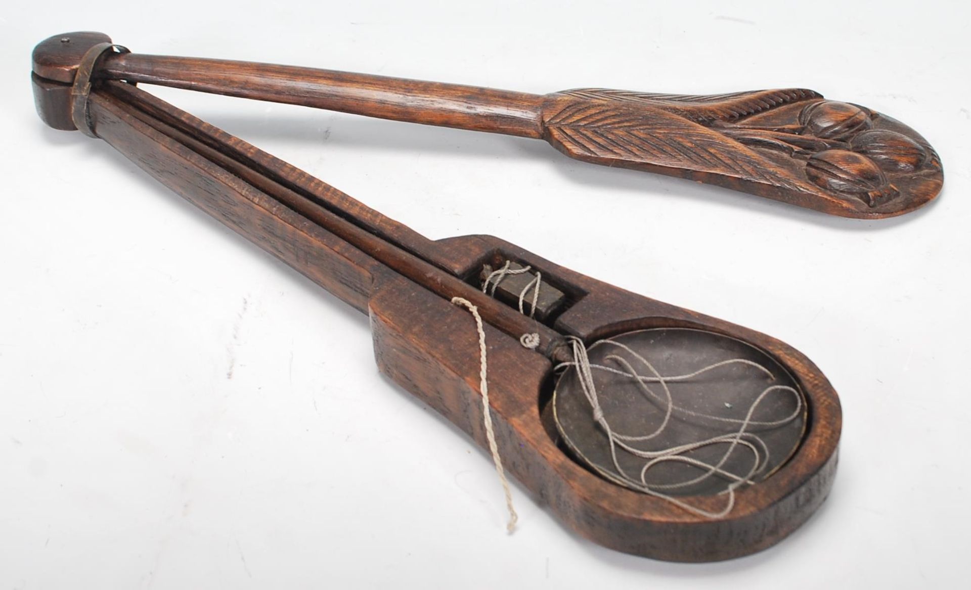 A set of 20th Century Chinese opium scales having a carved wooden case with rotating lid having