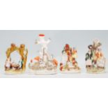 A group of four 19th Century Victorian Staffordshire spill / tulip vases each adorned with figures