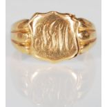 A hallmarked 18ct gold signet ring having an armorial crest to the head engraved with initials